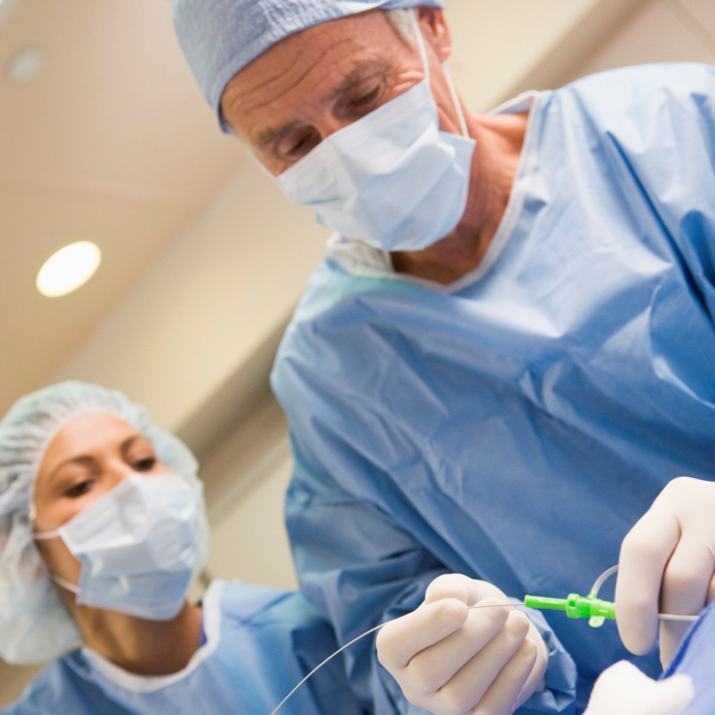Surgeons preparing equipment for surgery