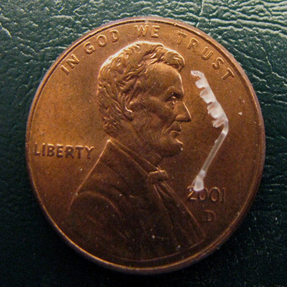 Injection Molded bioabsorbable polymer implant on a penny