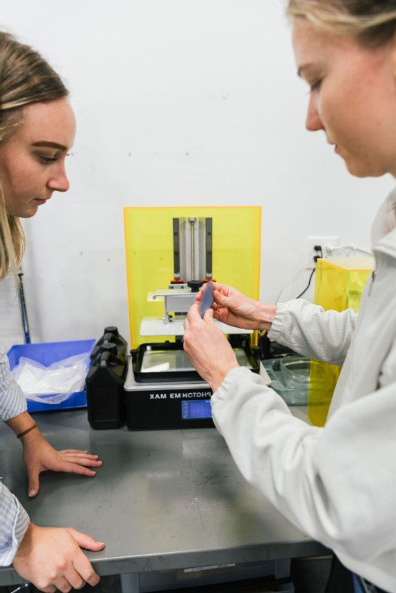 Medical Murray manufacturing technicians examing medicial device