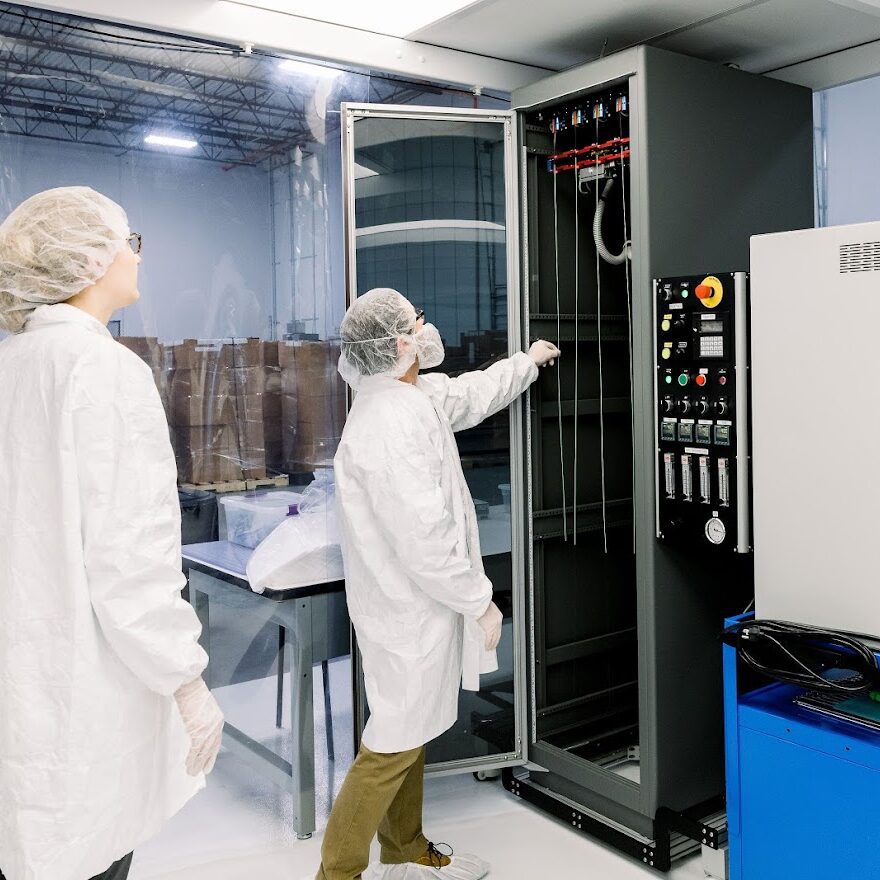 Technicians in clean room testing device prototypes