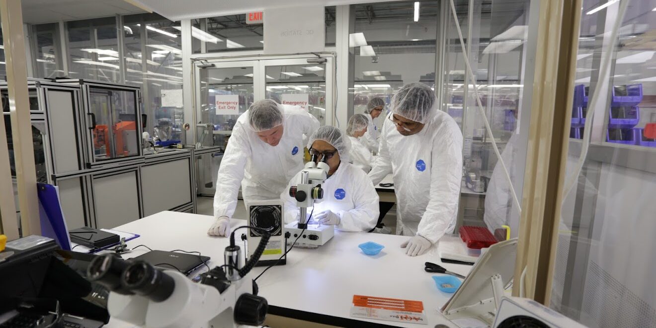 Technicians in clean room examining medical devices